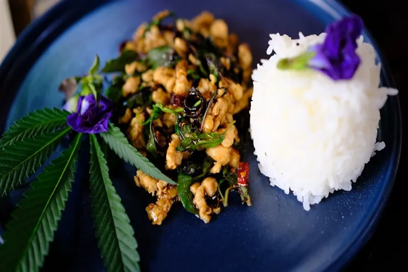 Finished Thai meal decorated with edible flowers and herbs