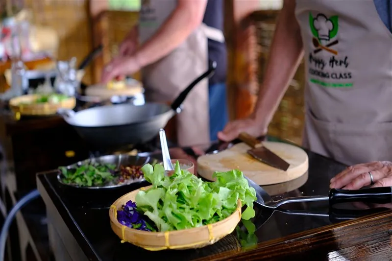Fresh vegetables being prepared beside a hot wok
