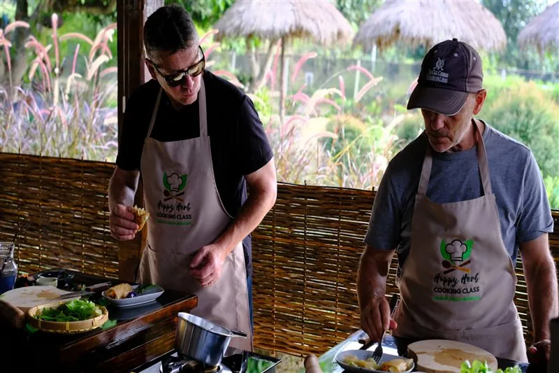 Visitors sharing fresh garden ingredients before cooking