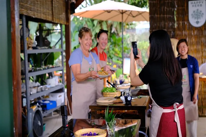 Students cooking together in the open-air pavilion