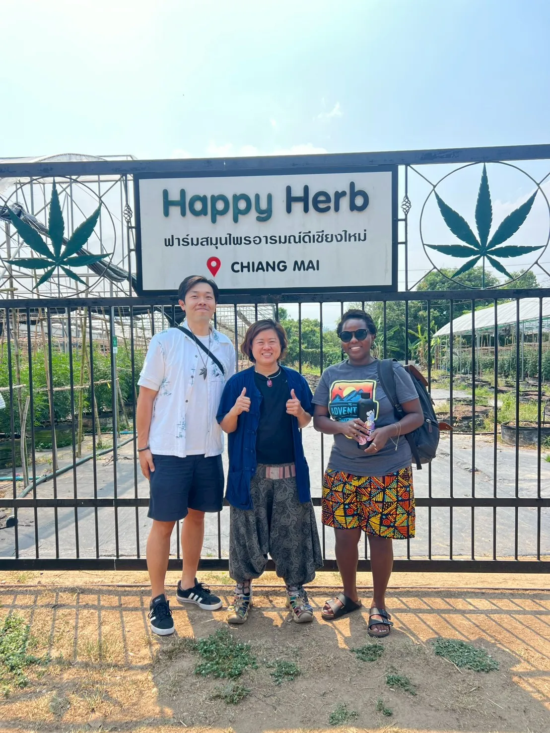 Visitors posing together at the Happy Herb farm entrance