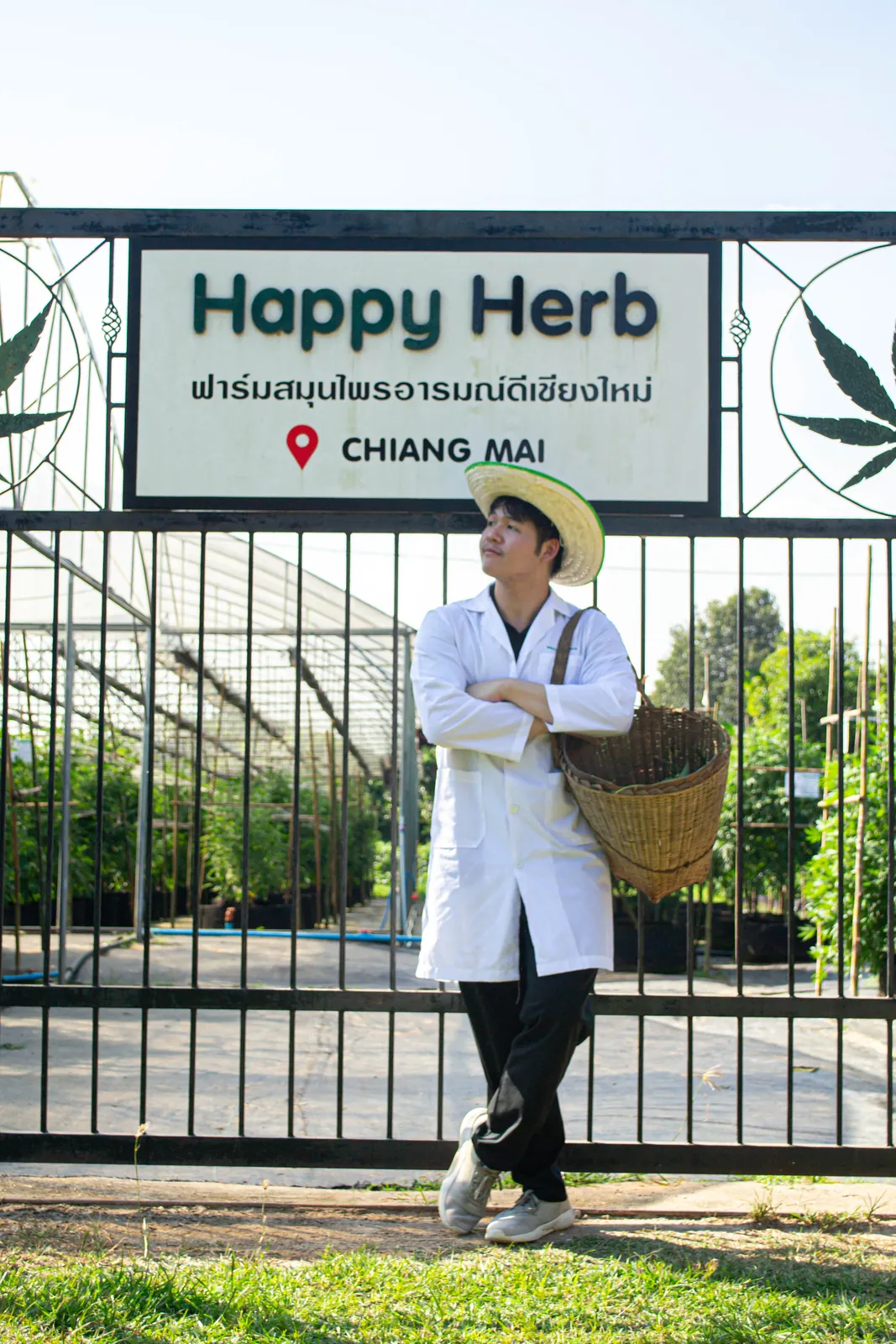 Farm guide posing beneath the Happy Herb entrance sign