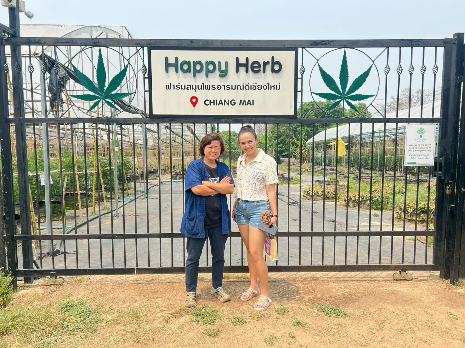 Travellers posing together at the Happy Herb farm gate