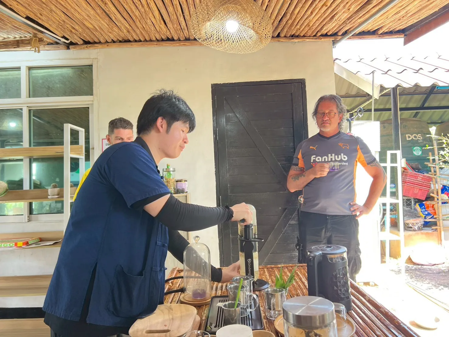 Happy Herb team member demonstrating seed and propagation work
