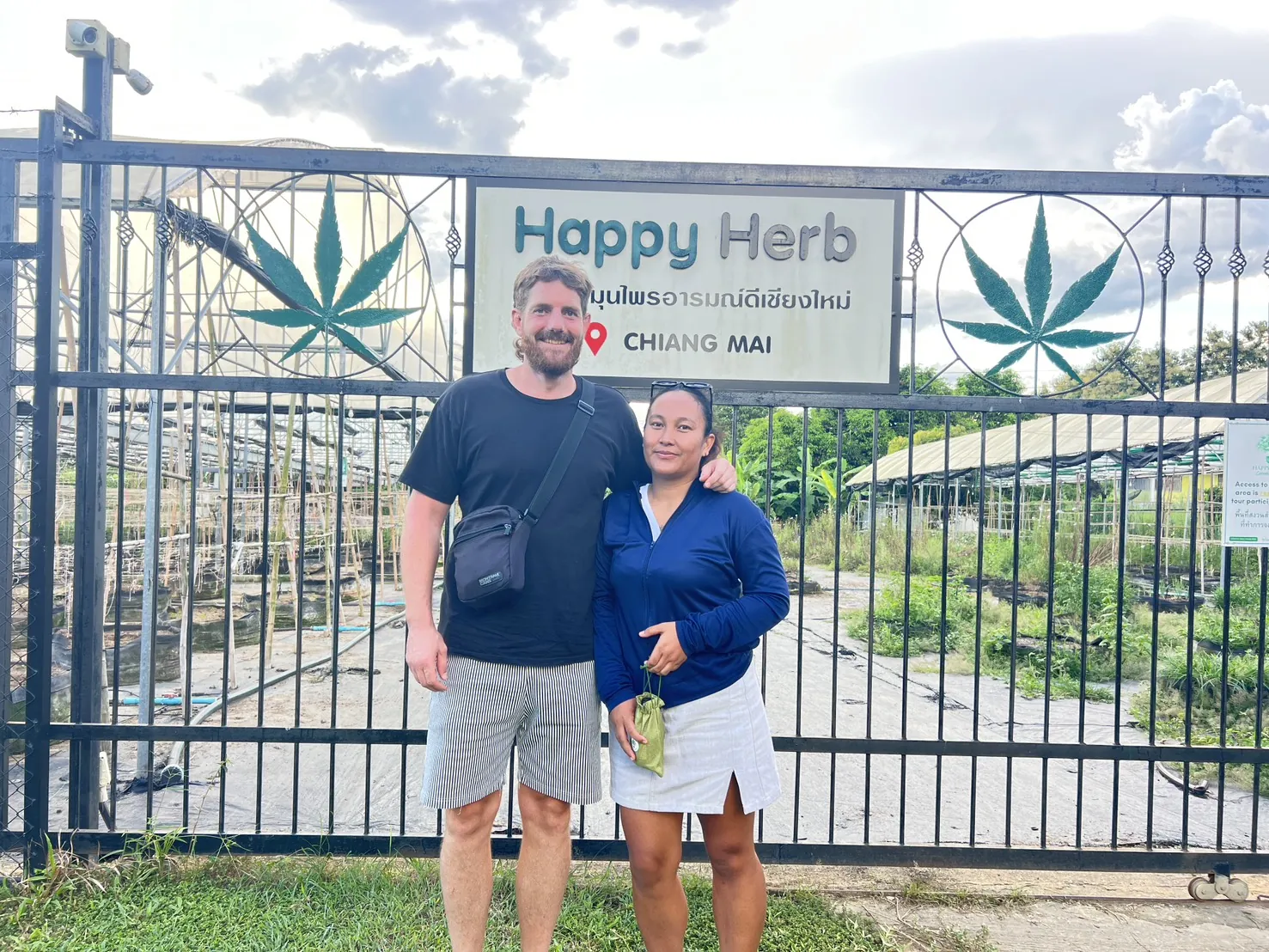 Guest posing with the Happy Herb team at the entrance